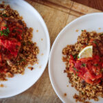 uicy Za’atar Chicken Thighs with golden skin and roasted tomato anchovy topping”