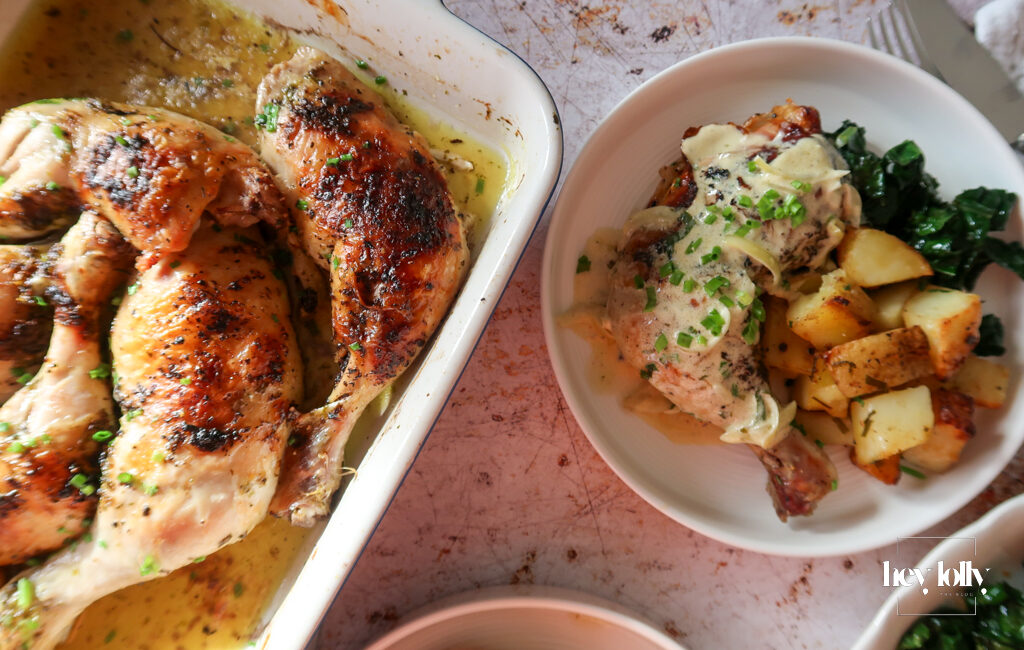 overhead shot of plated garlic roast butter chicken with lemon cavolo nero