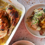 overhead shot of plated garlic roast butter chicken with lemon cavolo nero