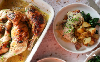 overhead shot of plated garlic roast butter chicken with lemon cavolo nero
