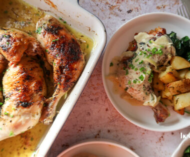 overhead shot of plated garlic roast butter chicken with lemon cavolo nero