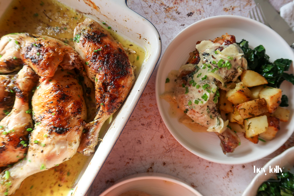 overhead shot of plated garlic roast butter chicken with lemon cavolo nero