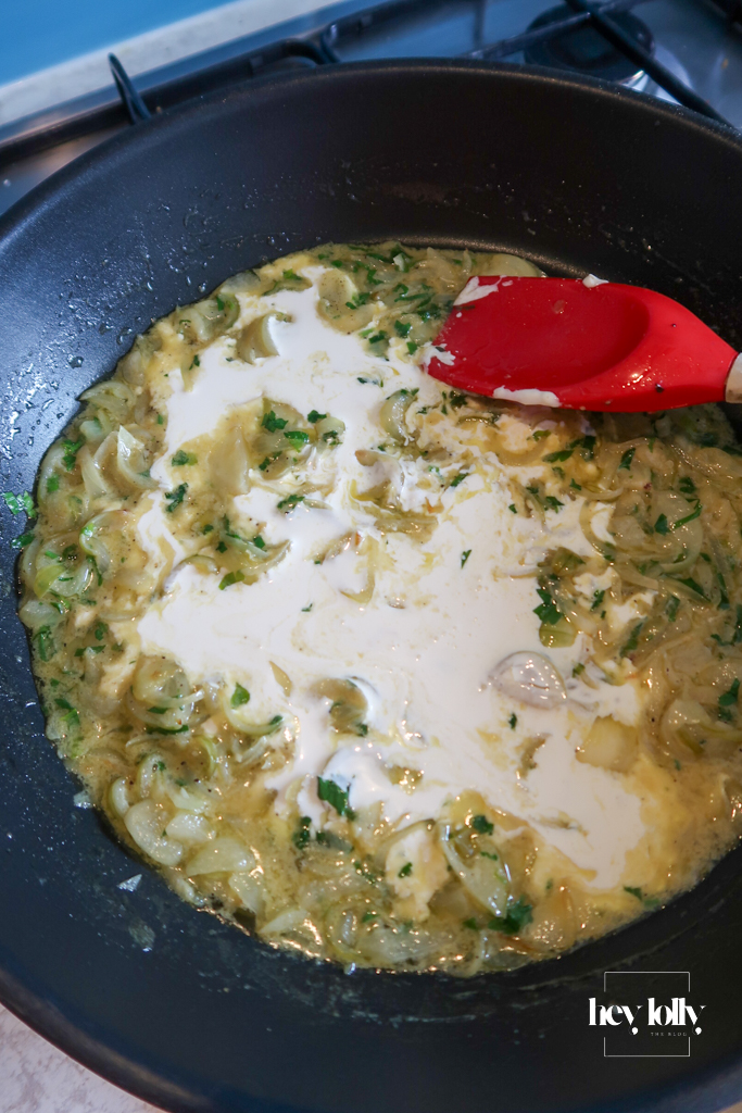 Shallots, cream and mustard simmering in a small pan with cream for Dijon sauce to serve with garlic butter roast chicken.