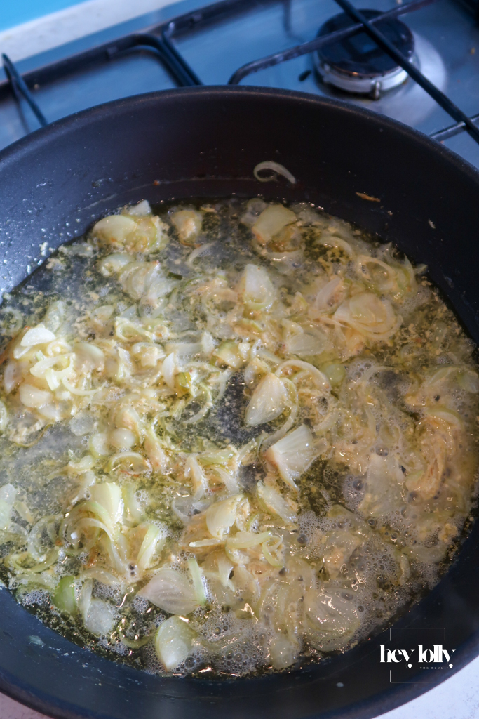 Shallots and mustard simmering in a small pan with cream for Dijon sauce to serve with garlic butter roast chicken.