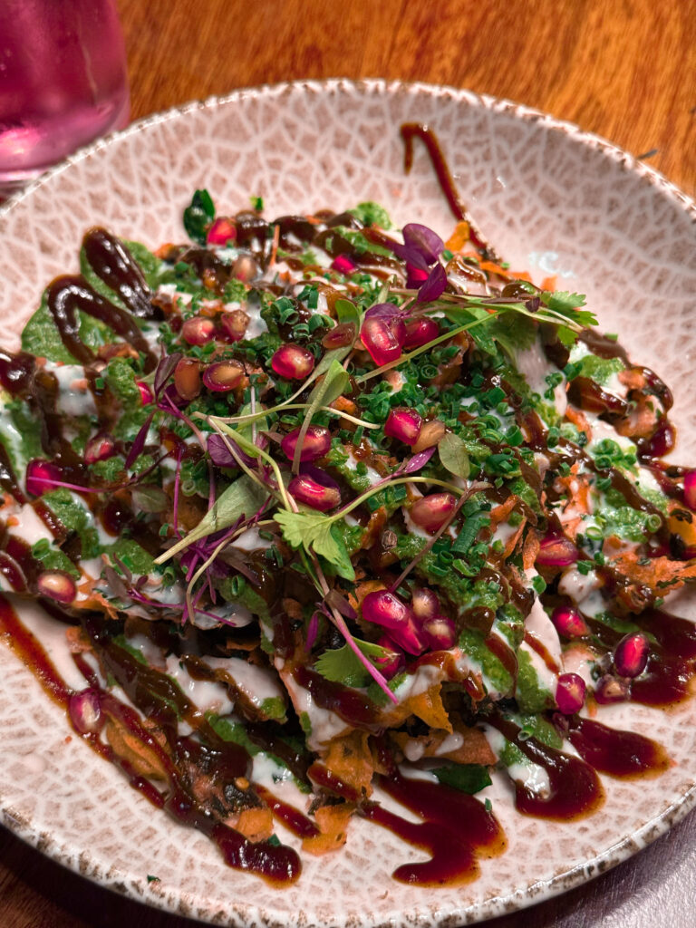 Palak Patta Chaat at Passan’s Nottingham — crisp spinach leaves topped with yoghurt, tamarind, and pomegranate.