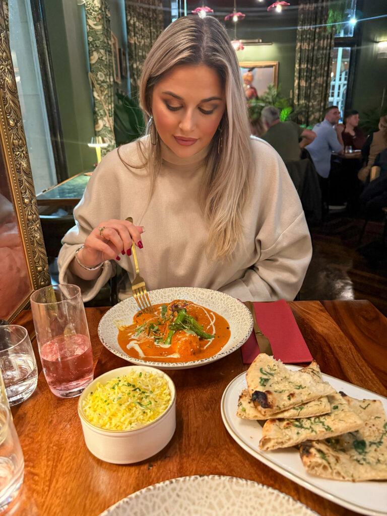 hey lolly looking down at a bowl of malai chicken