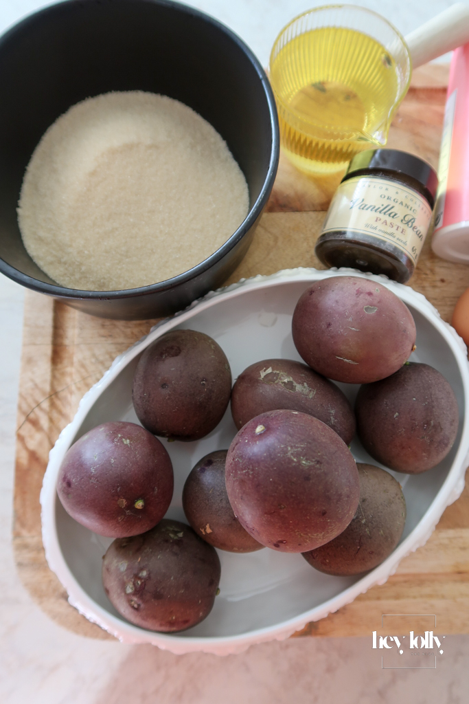 Ingredients for passion fruit yoghurt loaf laid out on kitchen counter — passion fruits, sugar, and vanilla.