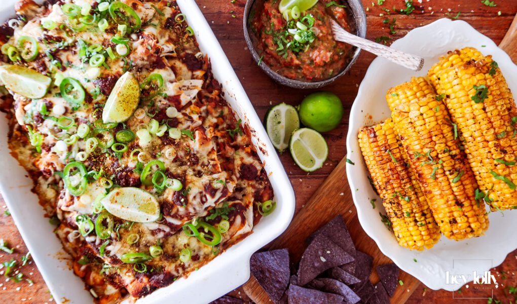 overhead shot of sweetcorn and butter bean enchiladas with salsa and tortilla chips