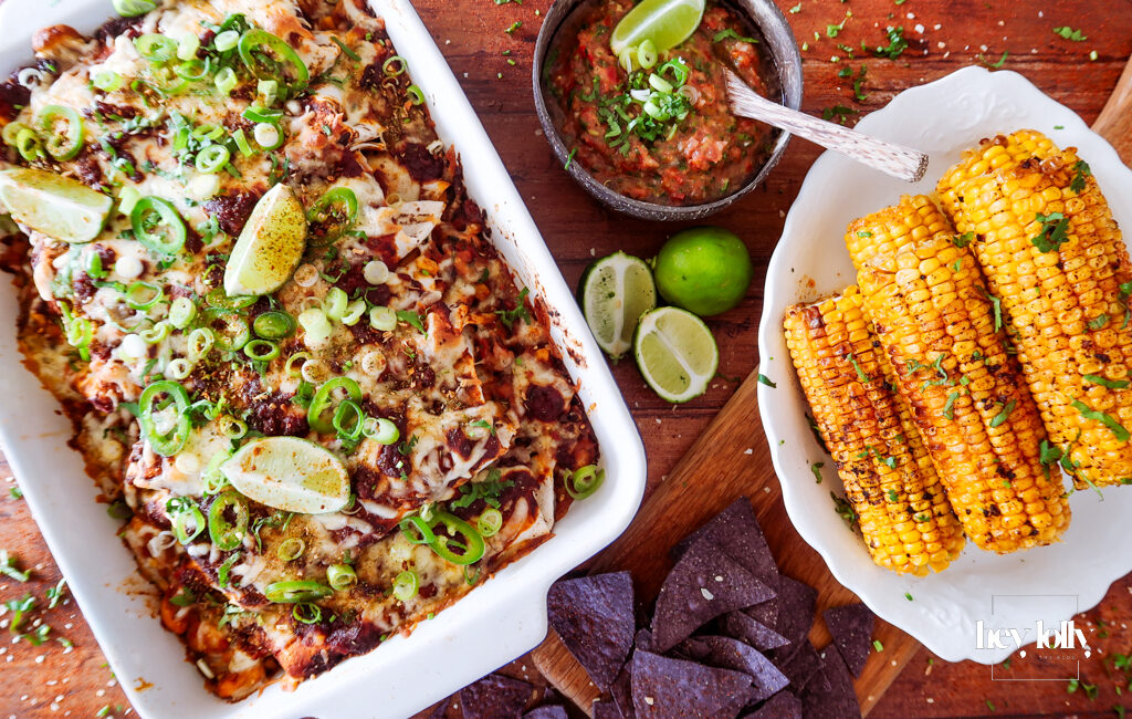 overhead shot of sweetcorn and butter bean enchiladas with salsa and tortilla chips