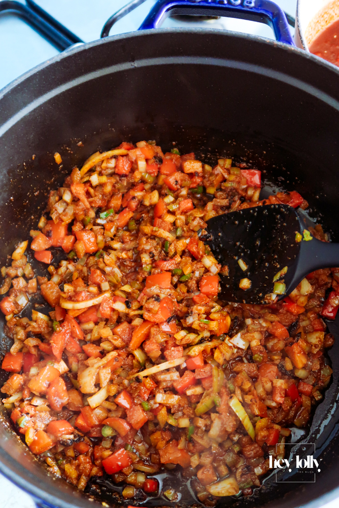 Diced onion, red pepper and corn sizzling together in olive oil for the enchilada filling.