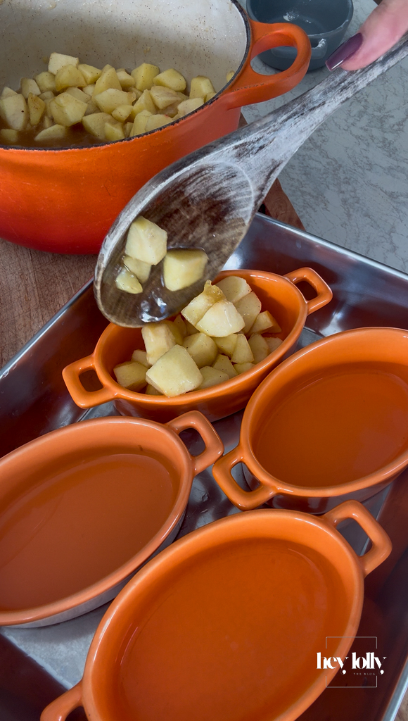 Warm cinnamon apples divided into four ramekins for apple and miso caramel crumble.
