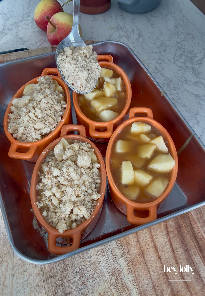 Generous crumble topping mounded over each ramekin; rough and craggy for maximum crisp.