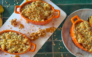 Apple and miso caramel crumble in white ramekins, bronzed sandy topping and glossy caramel drizzle.