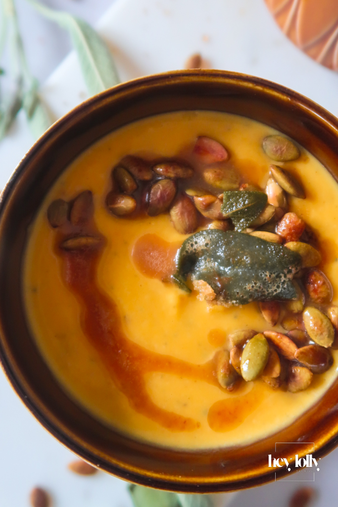 Close-up of Butternut Squash Soup with Sage Brown Butter showing nutty sheen and crunchy seeds
