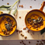 Bowls of Butternut Squash Soup with Sage Brown Butter, crisp sage and toasted pumpkin seeds