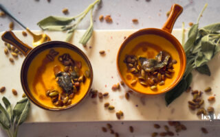 Bowls of Butternut Squash Soup with Sage Brown Butter, crisp sage and toasted pumpkin seeds