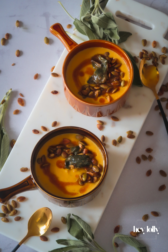 Two bowls of butternut squash soup with crisp sage — weeknight dinner setup