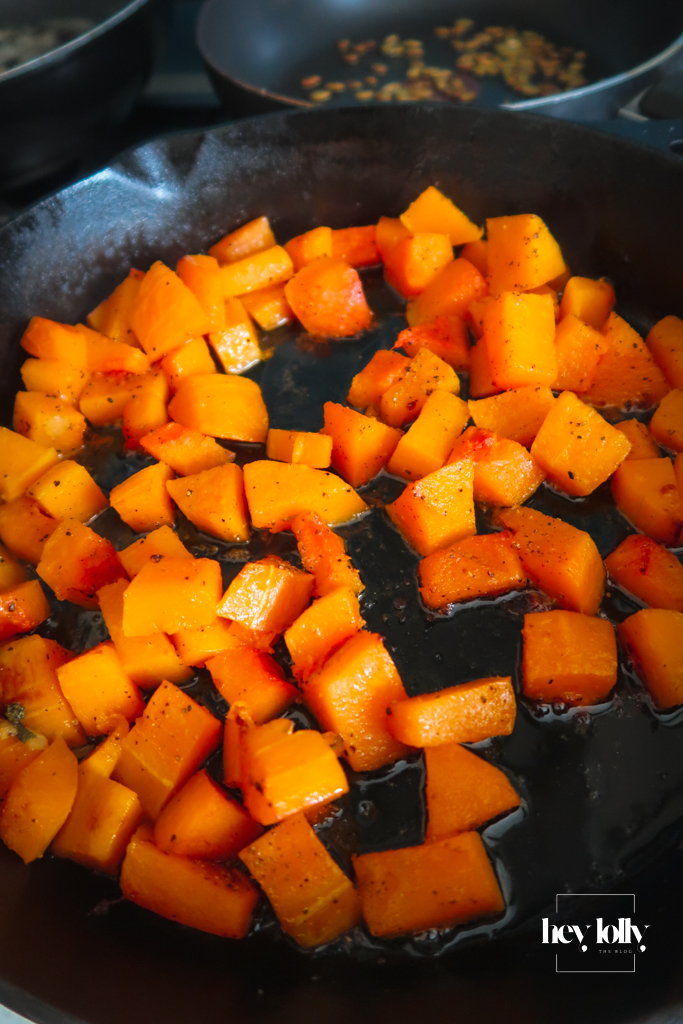 Roasted butternut squash cubes with caramelised edges on a baking tray