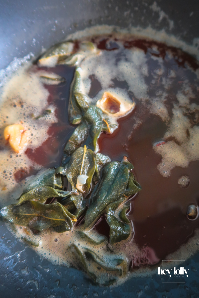 Butter foaming and browning in a small pan, milk solids turning hazelnut brown