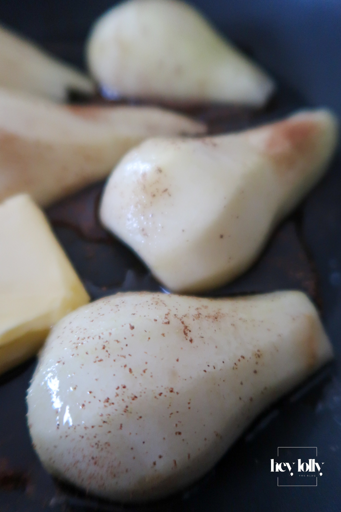 Pears caramelising in butter and maple syrup – Pear slices caramelising in maple syrup and butter for a golden, autumn porridge topping.