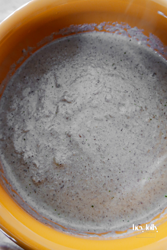 Cream swirled into the soup, turning the broth pale and velvety.