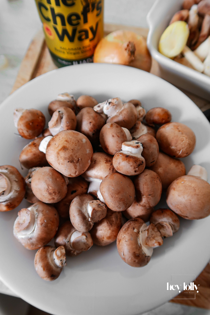 Chestnut mushrooms spread in an even layer ready to saute