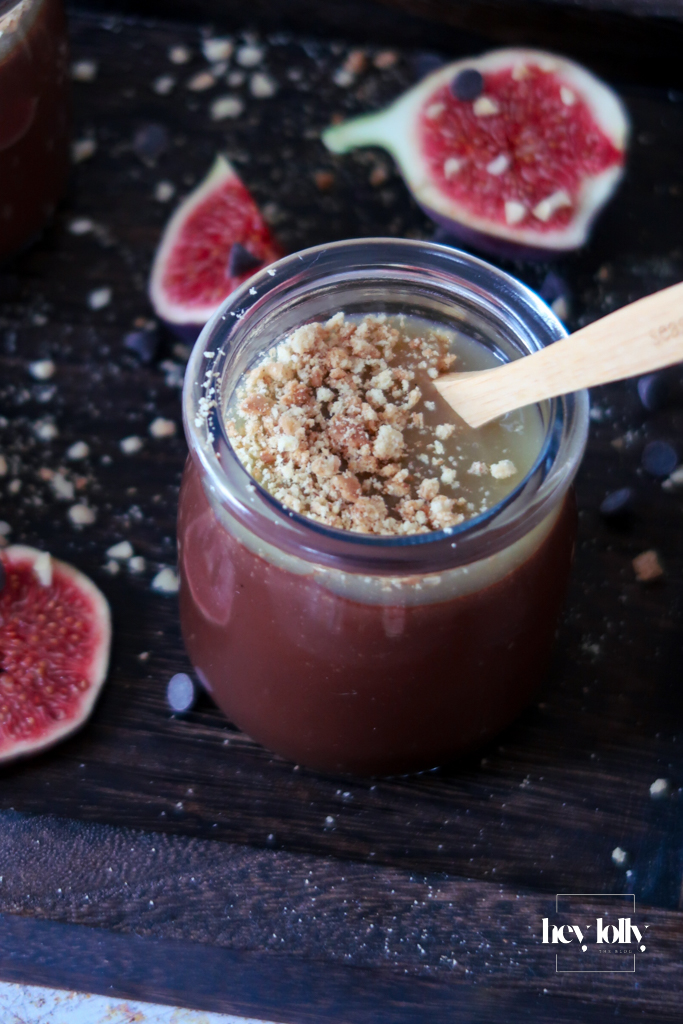 Two Salted Caramel Chocolate Pots on a table with spoons, styled for a cosy dessert moment.