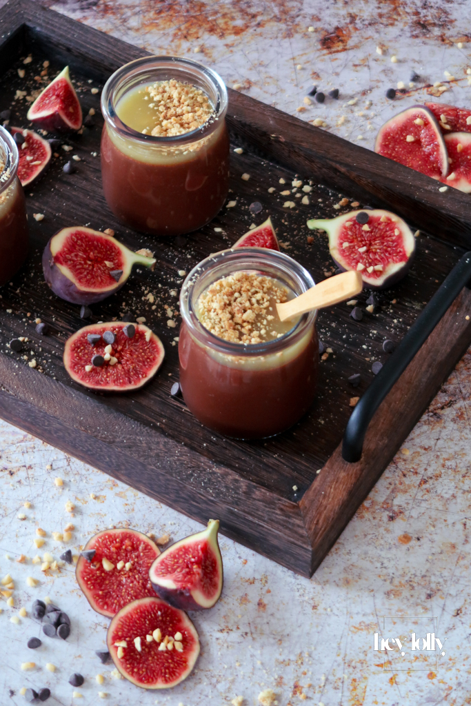 Two Salted Caramel Chocolate Pots on a table with spoons, styled for a cosy dessert moment.