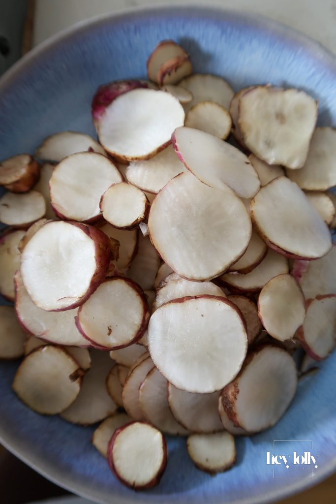 Fresh sliced Jerusalem artichokes on a board before peeling and slicing