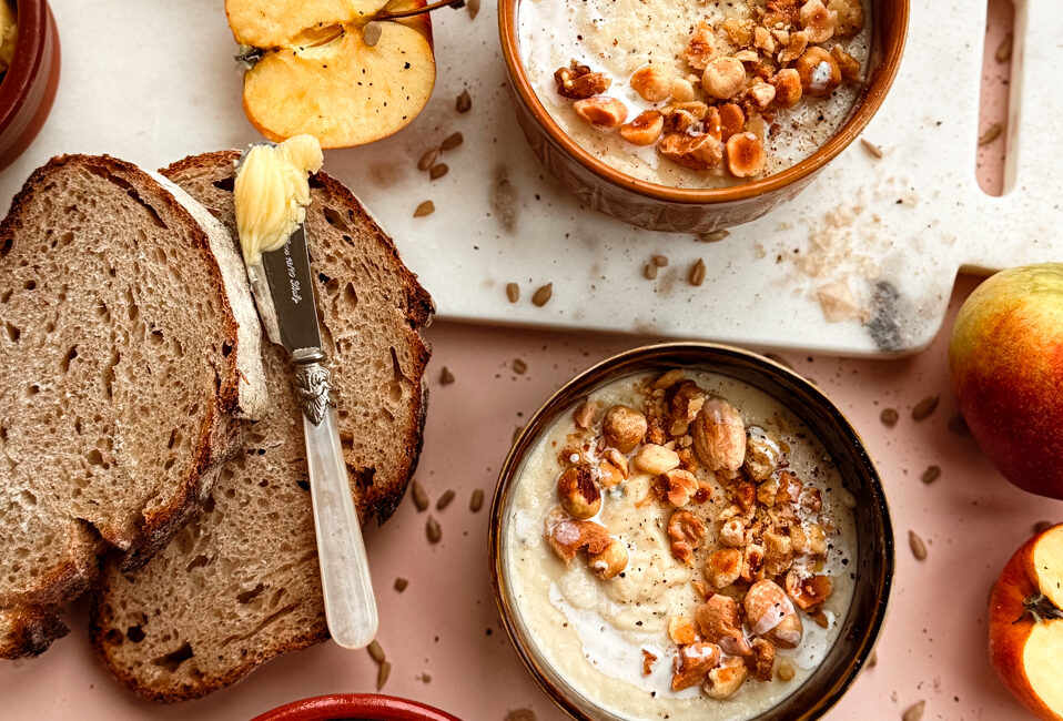 Bowl of celeriac and Bramley apple soup with brown-butter sage and walnuts.