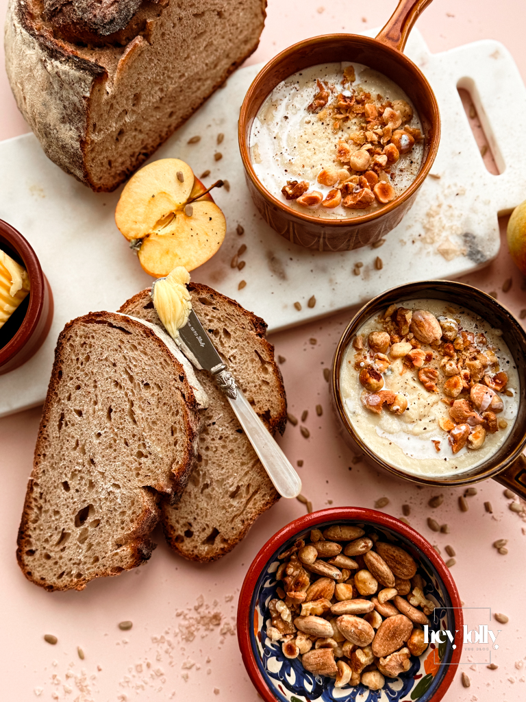 Cosy winter table with bowls of celeriac and Bramley apple soup.
