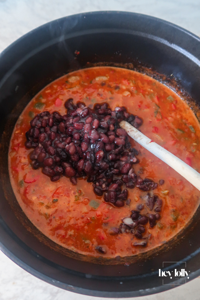 Tinned tomatoes, black beans being added to the Cowboy Taco Soup pot