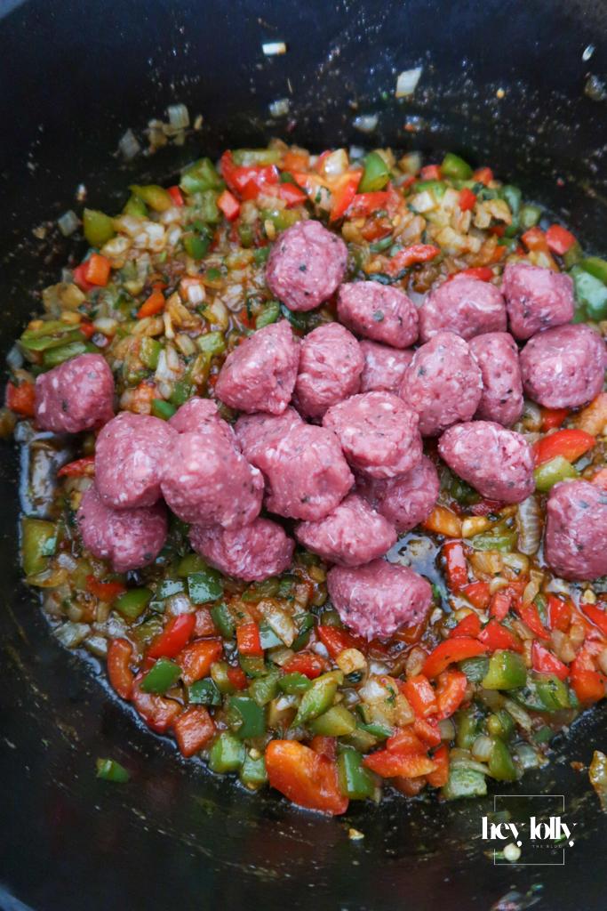 Onion and peppers and beef mince softening in a pot for Cowboy Taco Soup, edges just catching