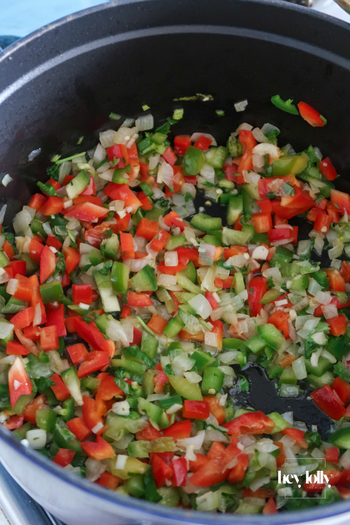 Onion and peppers softening in a pot for Cowboy Taco Soup, edges just catching