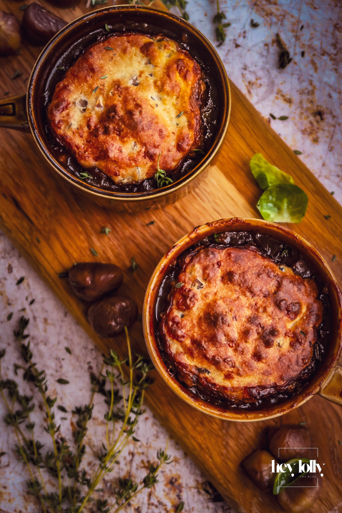 Herby chestnut and cheddar beef cobbler in a rustic baking dish, golden cobbles over bubbling beef cobbler stew.