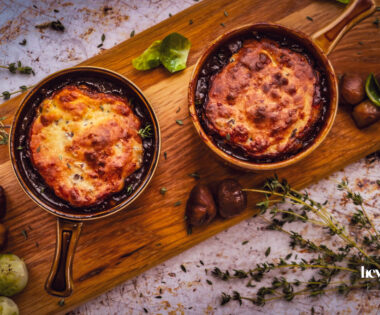 overhead shot of bubbling pots of herby chesnut and cheddar beef cobbler