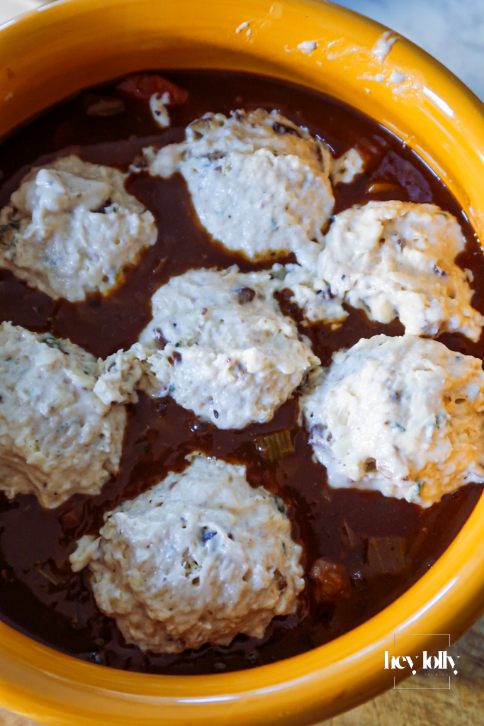 Unbaked cheddar and chestnut cobbles arranged over the top of the beef stew before baking.