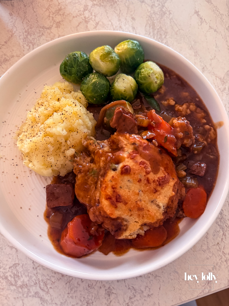 Herby chestnut and cheddar beef cobbler just out of the oven, served with mash potato, brussel sprouts