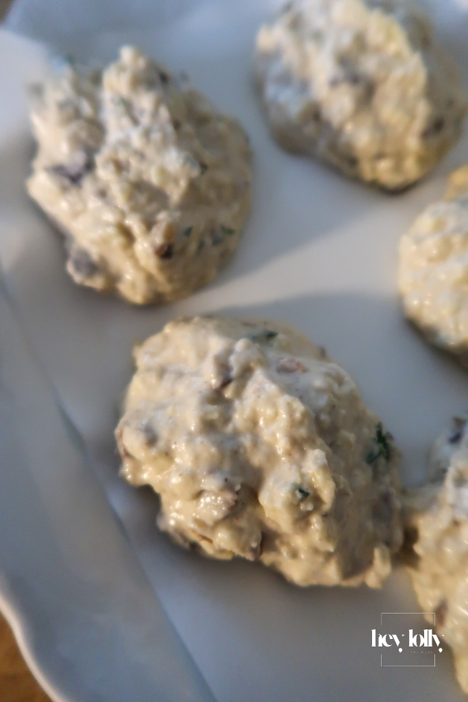 Cheddar and chestnut cobbler dough in a mixing bowl, flecked with thyme and ready to shape.