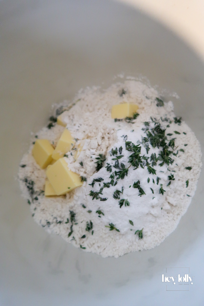 Cheddar and chestnut cobbler dough in a mixing bowl, flecked with thyme and ready to shape.