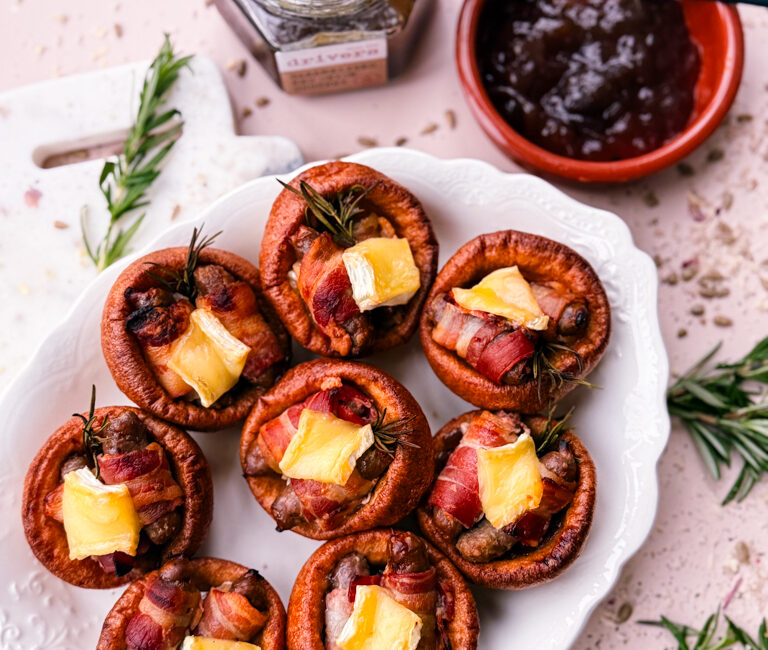 Casual plate with a couple of pigs in blankets Yorkshire puddings and extra gravy.