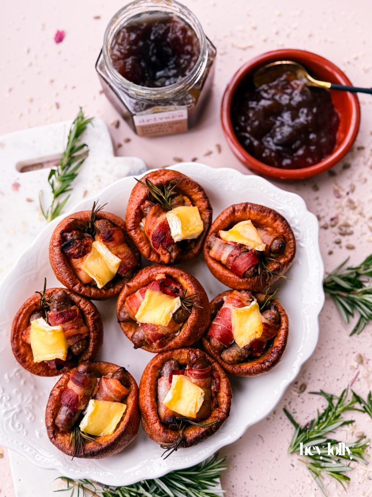 Casual plate with a couple of pigs in blankets Yorkshire puddings and extra gravy.