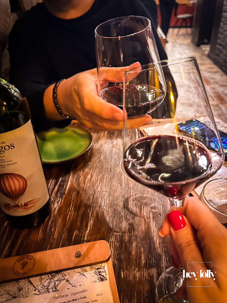 cheers enjoying a spanish rioja plates by purnell's