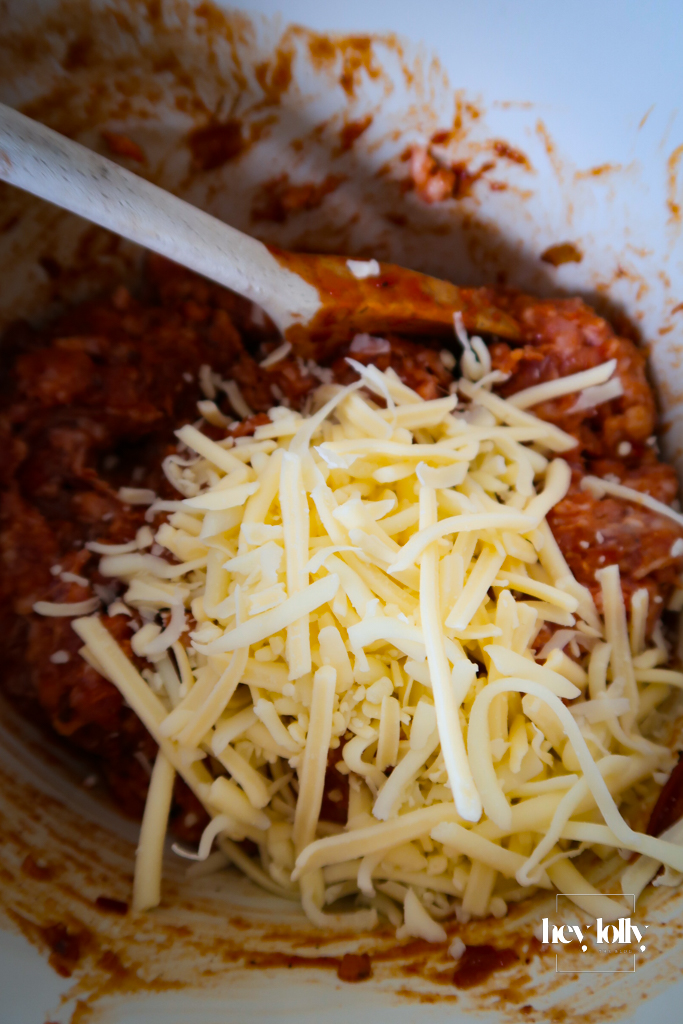 Close-up of seasoned sausage meat with cheddar cheese.
