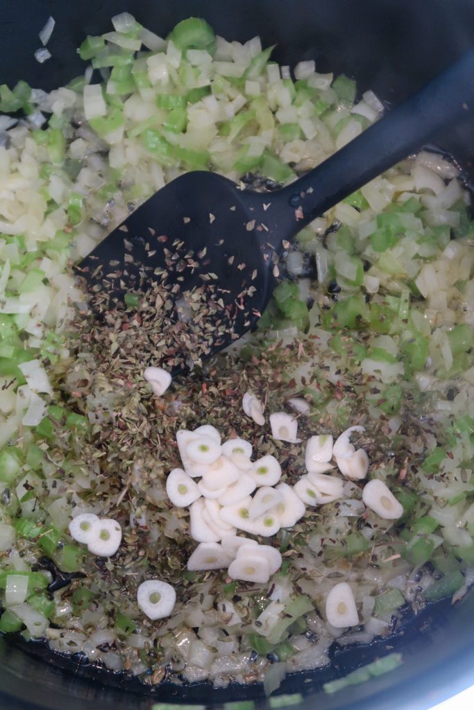Onions, celery and garlic softening in olive oil in a saucepan