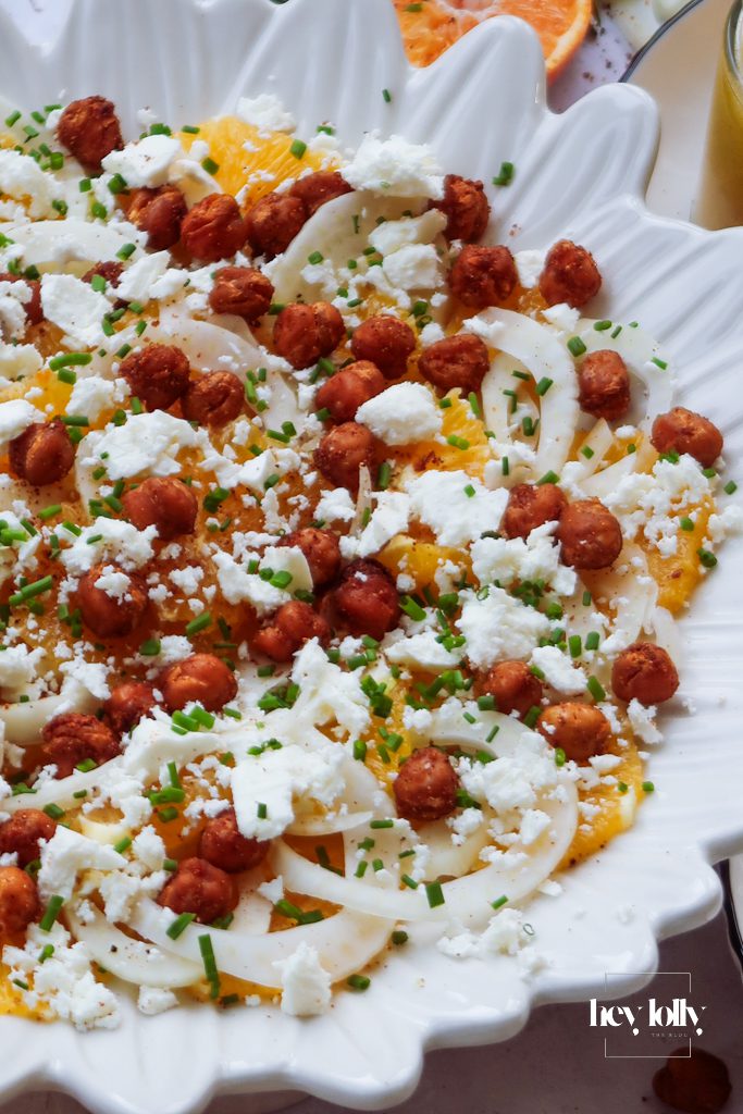 Orange fennel chickpea salad on a laid table ready to serve for dinner
