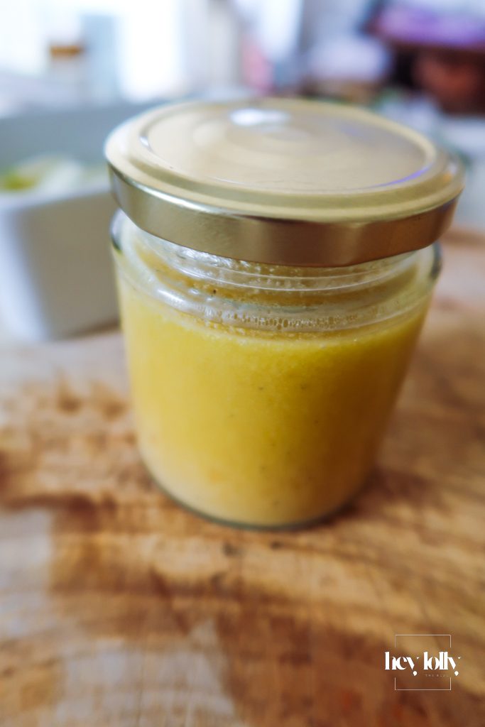 Citrus dressing for orange fennel chickpea salad in a small glass jar ready to pour