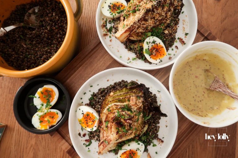 Overhead view of warm mustard lentils with charred cabbage, jammy eggs and garlic breadcrumbs in a shallow bowl