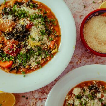 oven on world off pearl barley stew overhead shot in white bowls with grated parmesan and lemon zest