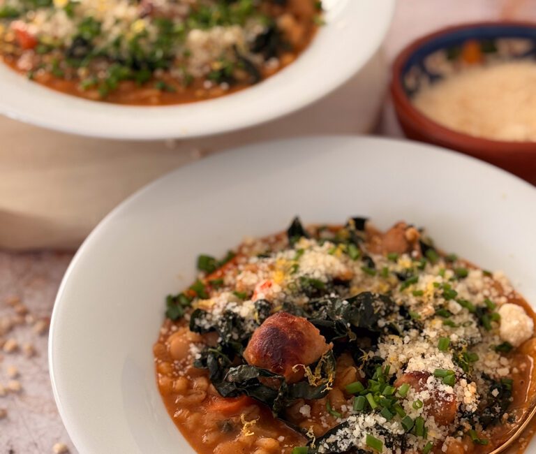 Close-up of pearl barley stew showing plump grains of barley, tender carrots and pieces of sausage